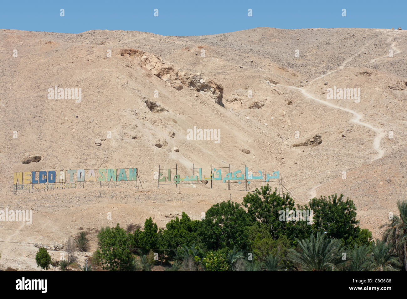 Welcome sign 'Hollywood' style with palms in front on the mountains at Sharona on the Aswan Luxor protectorate border, Egypt Stock Photo