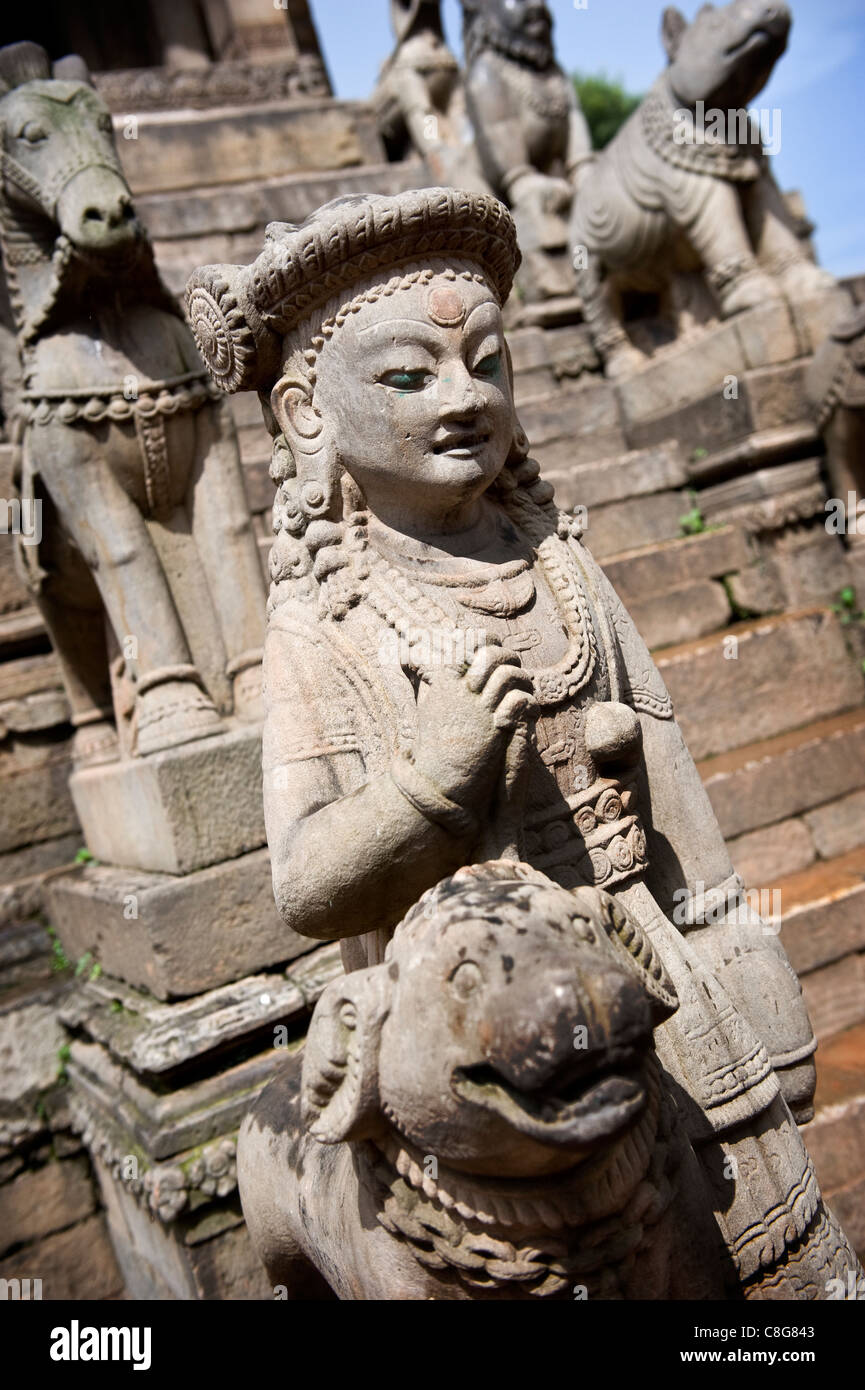 Stone guardians flank the staircase leading up to the Siddhi Lakshmi Temple, Durbar Square, Bhaktapur, Kathmandu valley, Nepal Stock Photo