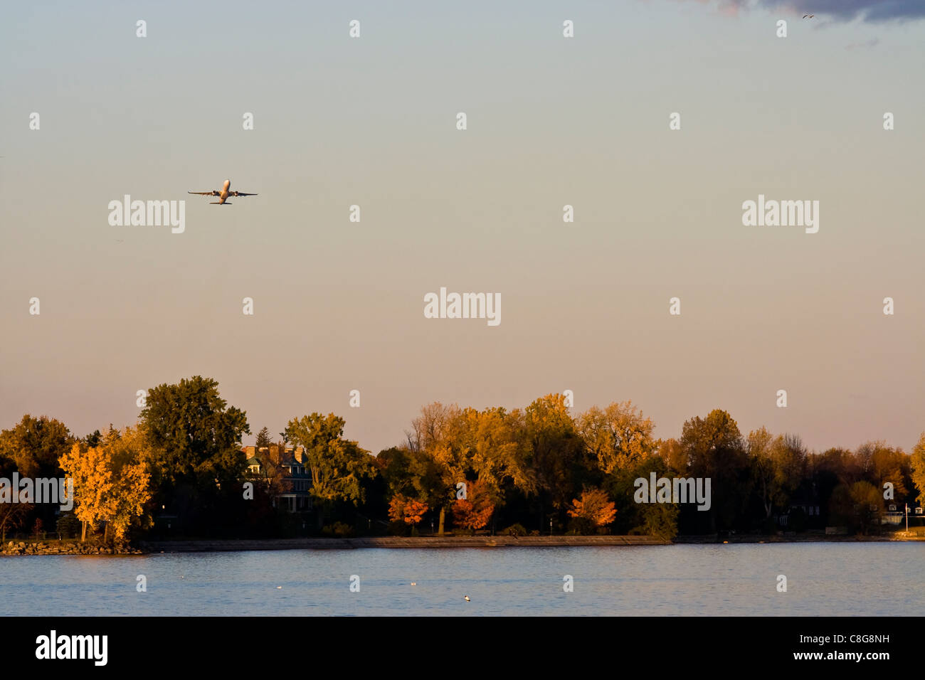 Indian summer in Montreal on Saint Lawrence river. Plane taking off from Pierre Elliot Trudeau International Airport. Stock Photo