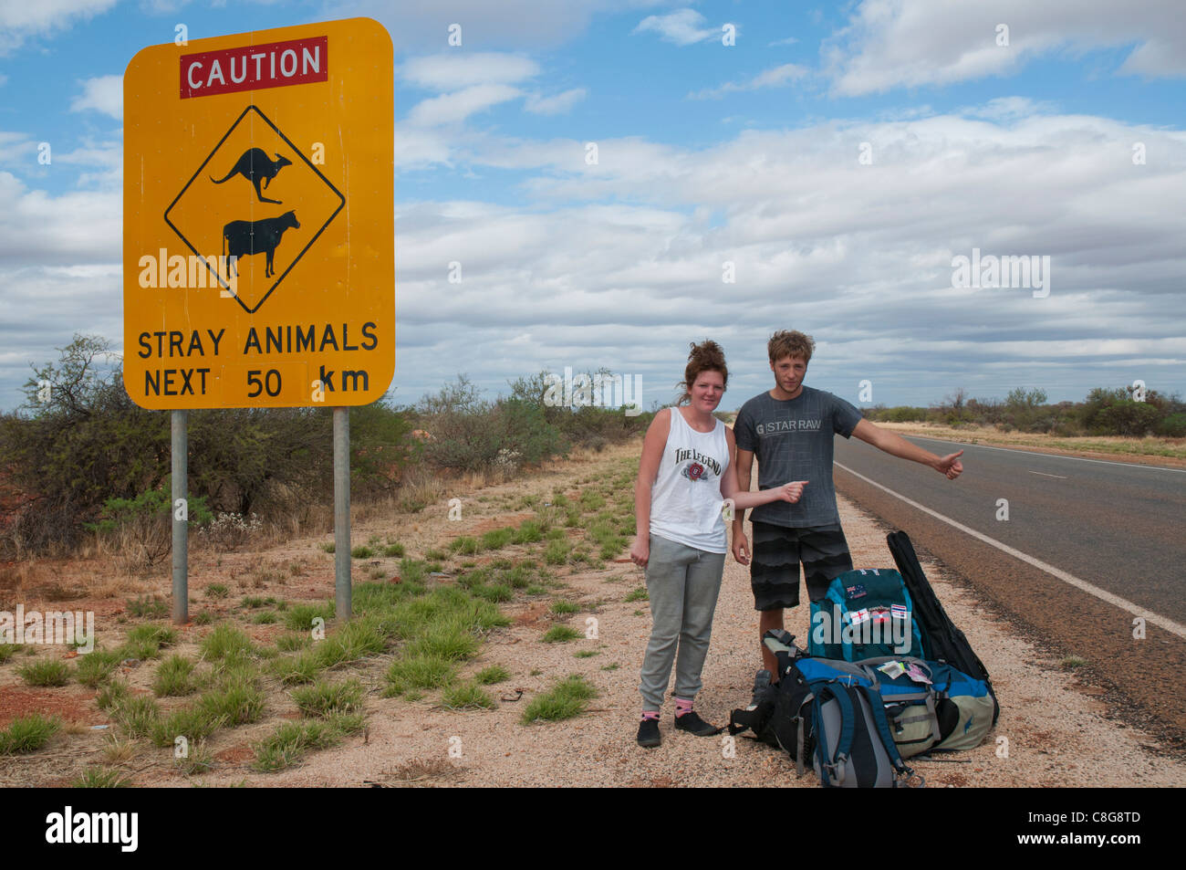 Two British backpackers hitchhiking to their next job on a working holiday in Western Australia Stock Photo