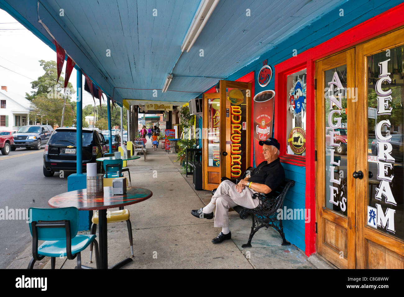 Elderly man sitting outside Ice Cream Parlor & Burger restaurant, East Bridge St, Breaux Bridge