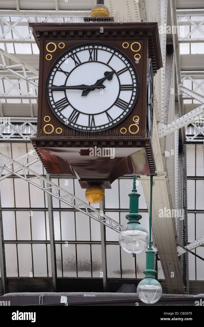 Big cube four sided clock hanging from the glass roof of the Central Station rail terminal in Glasgow, Scotland, UK, Europe. Stock Photo