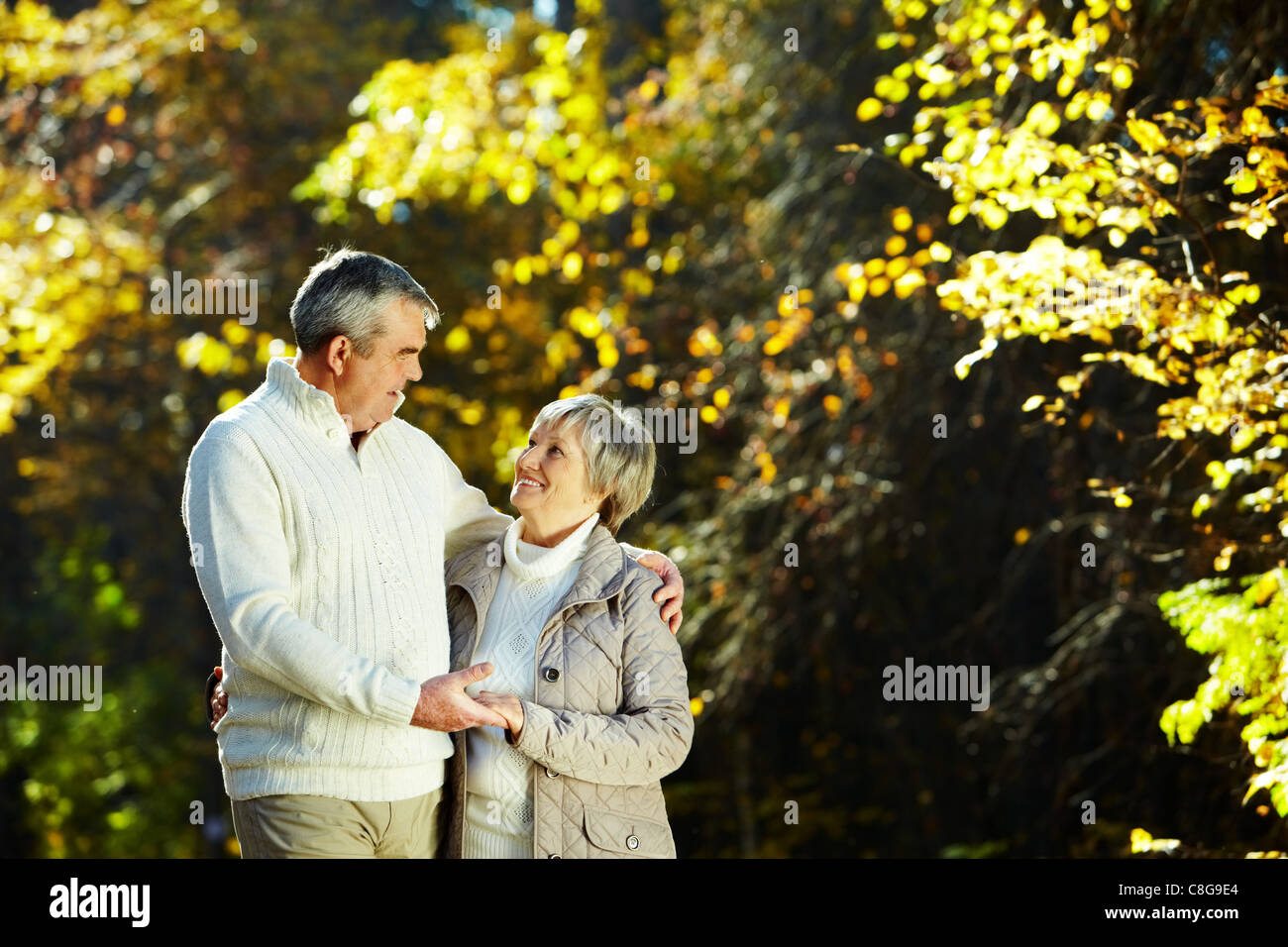 Photo of senior couple spending free time in park Stock Photo - Alamy