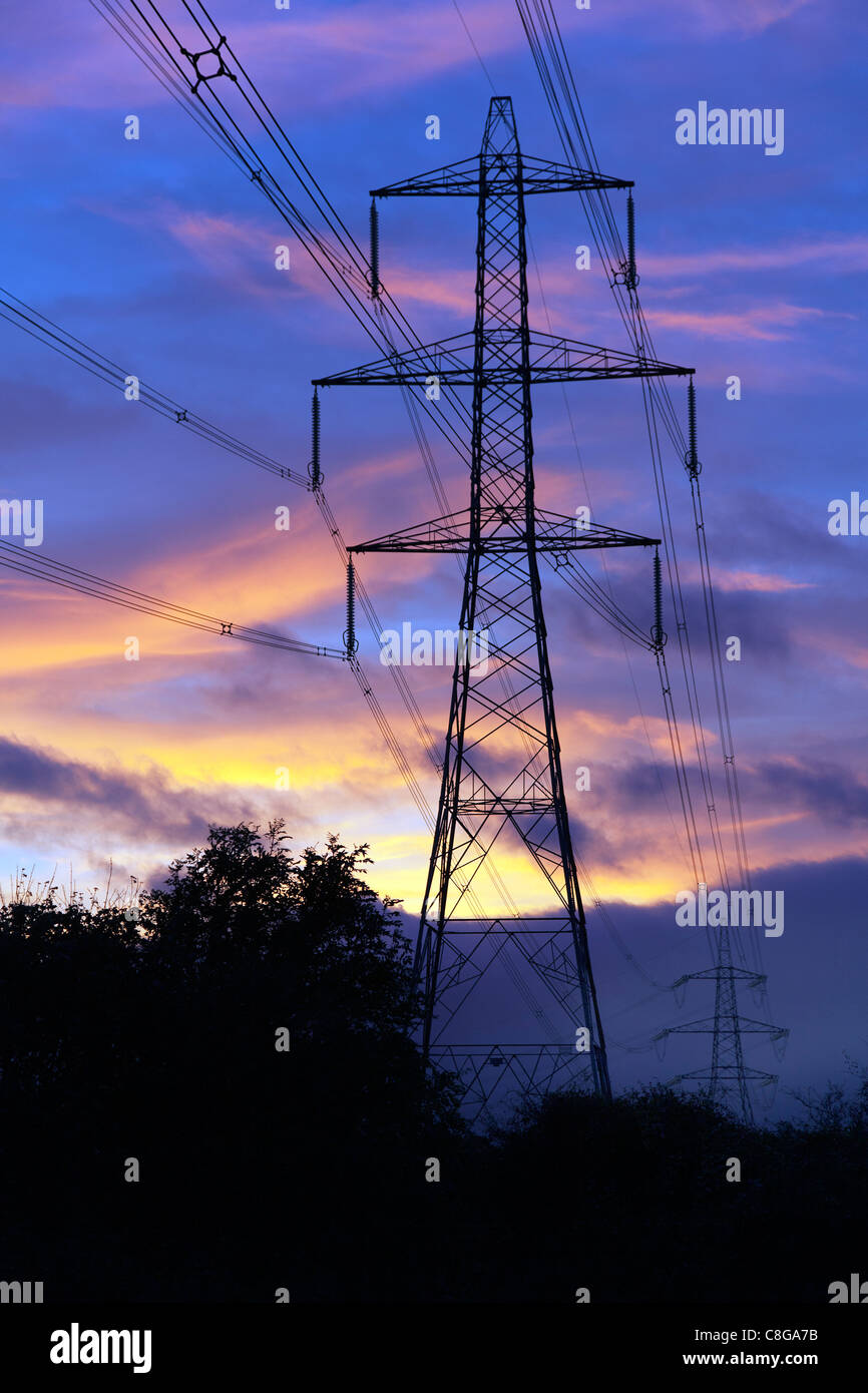 UK Pylon at dusk or dawn carrying  High Tension Electricity power supply cables Stock Photo