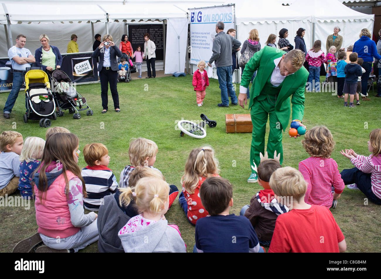 A kids entertainer presenting a little girl with three juggling balls