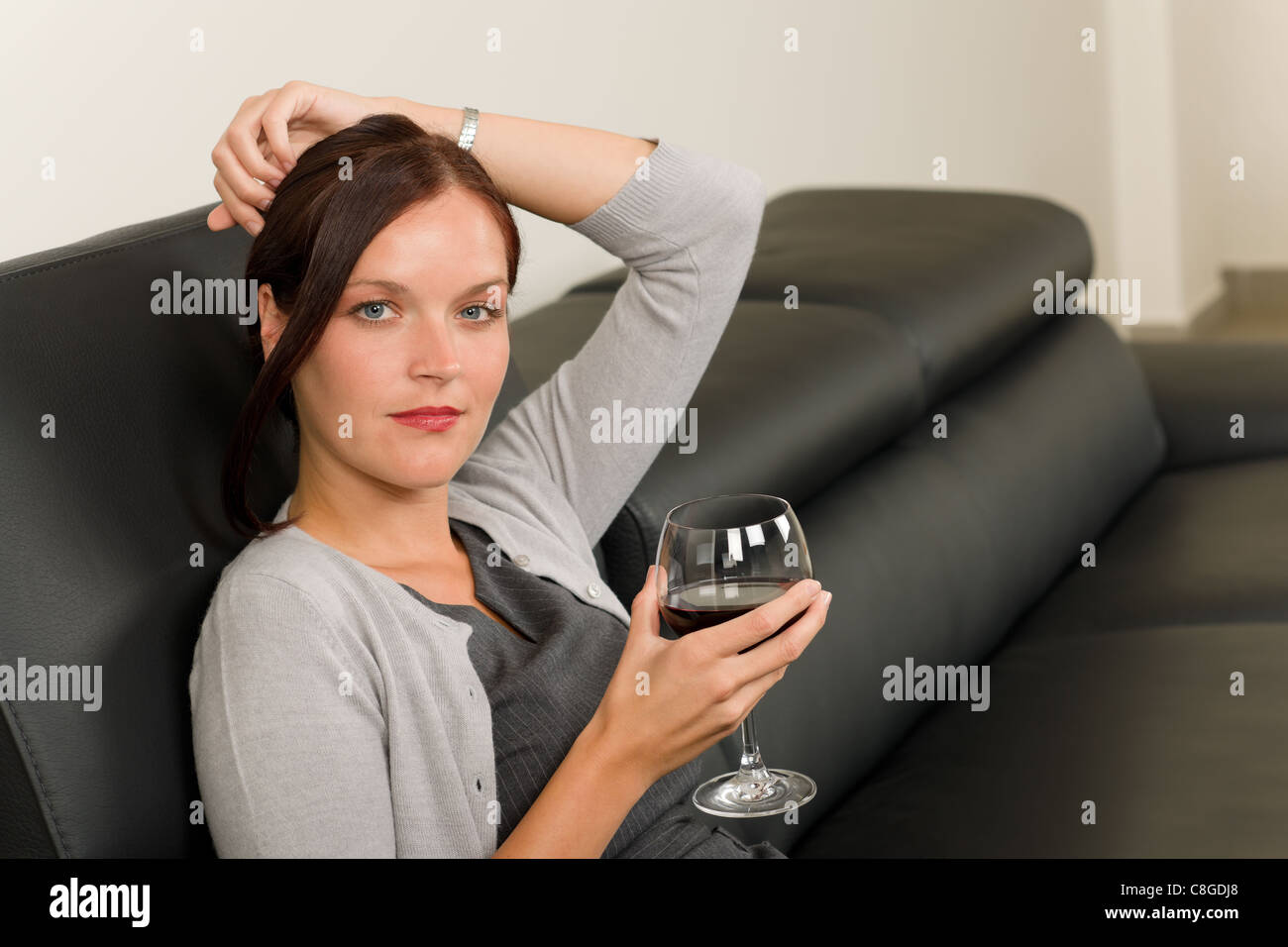 Elegant Businesswoman Sitting On Leather Sofa Drink Glass Red Wine