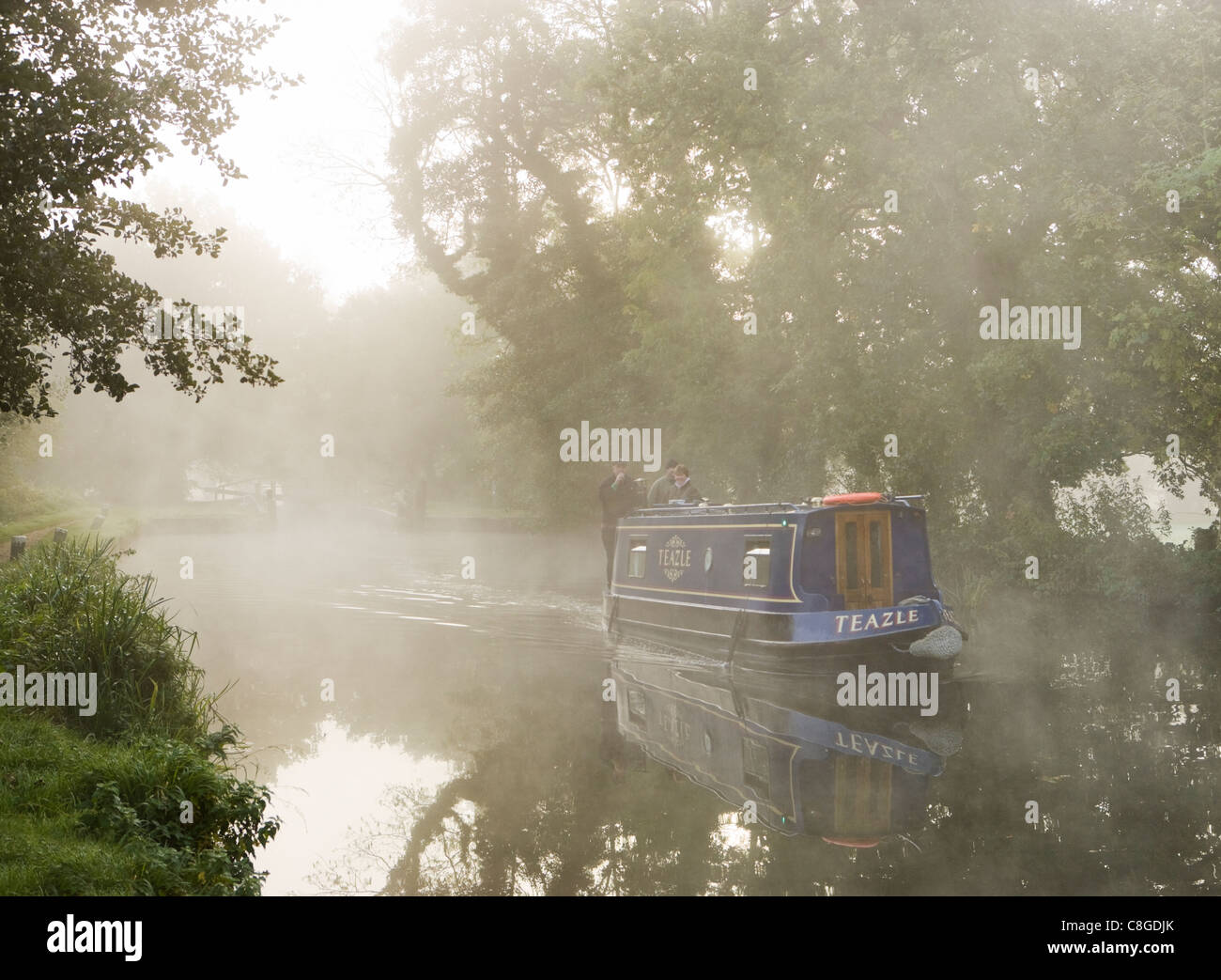 Misty dawn - boat on River Wey Navigation, Pyrford, Surrey, UK. Stock Photo