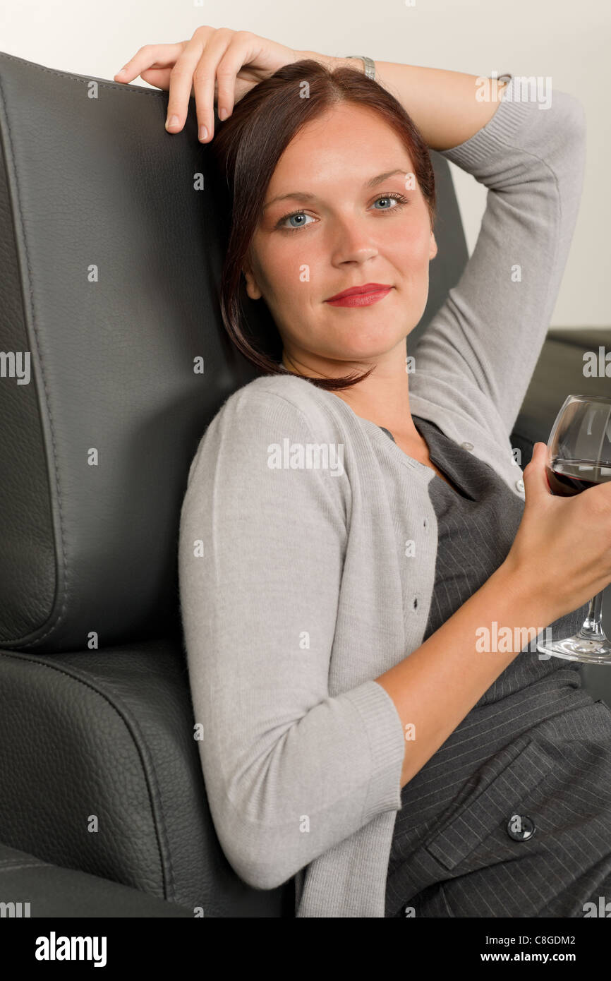 Elegant Businesswoman Sitting On Leather Sofa Drink Glass Red Wine