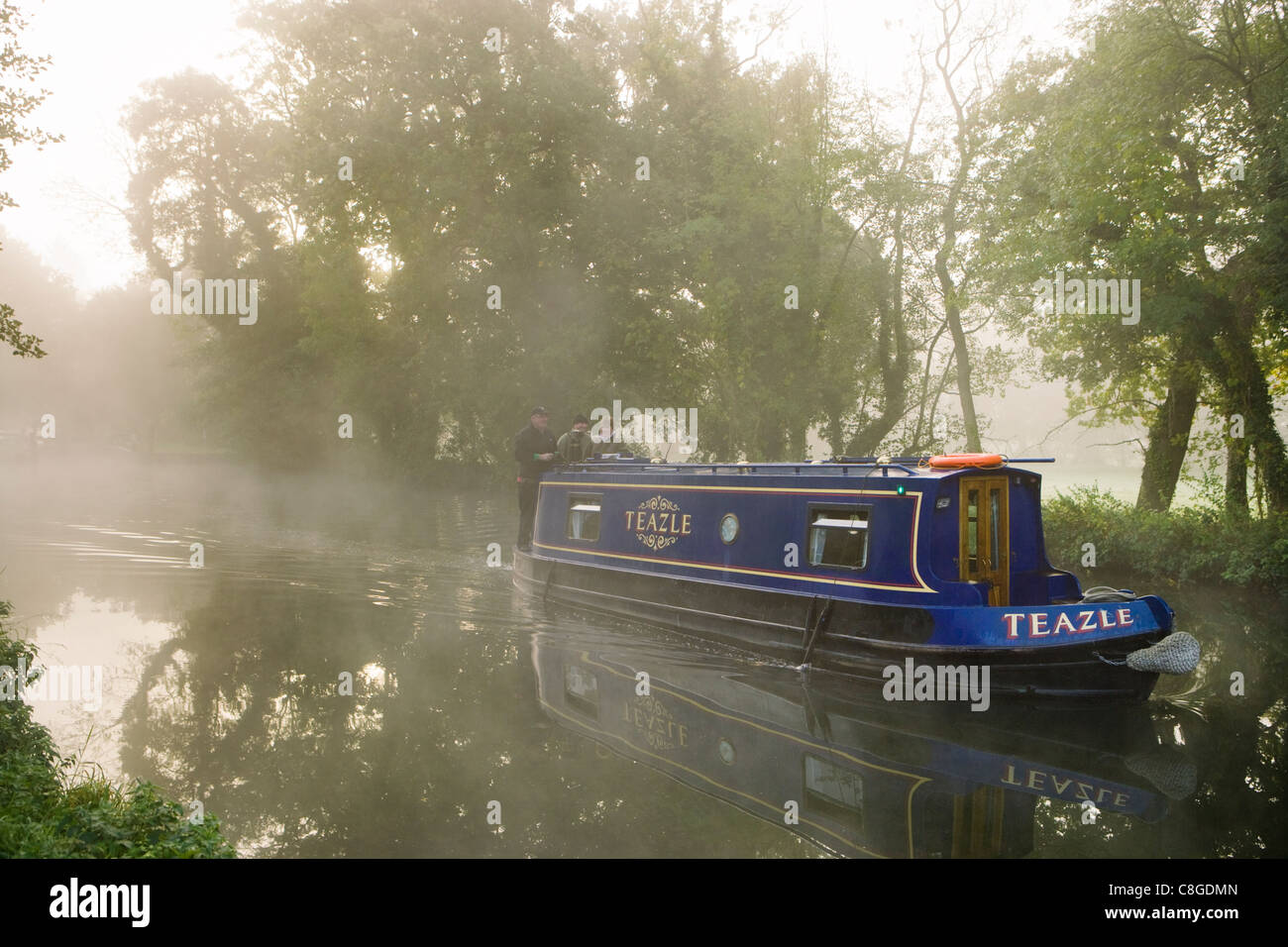 Misty dawn - boat on River Wey Navigation, Pyrford, Surrey, UK. Stock Photo