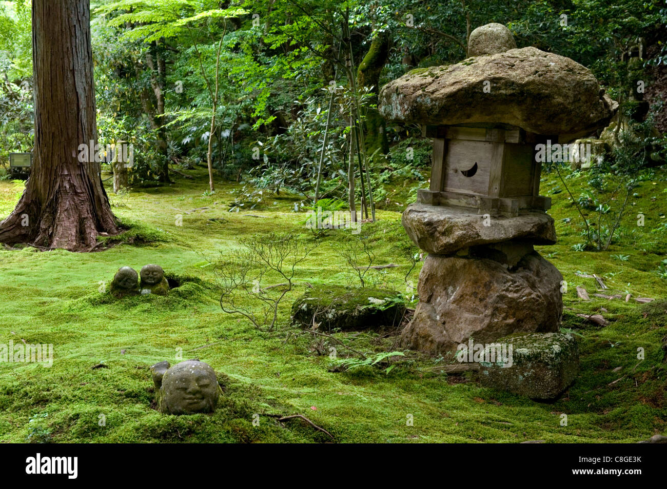 A rugged stone lantern accents a moss garden at Sanzenin Temple in Ohara, Kyoto, Japan Stock Photo