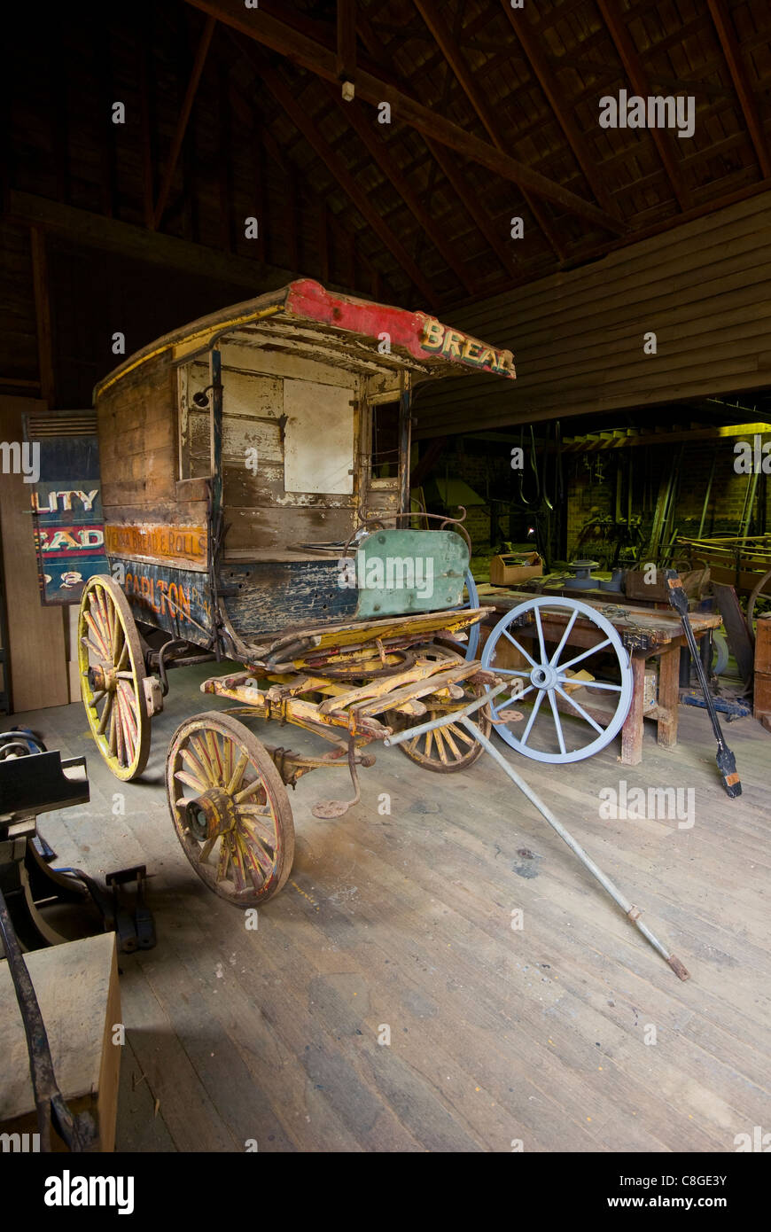 An antique stagecoach wagon being restored by skilled tradesmen. Stock Photo