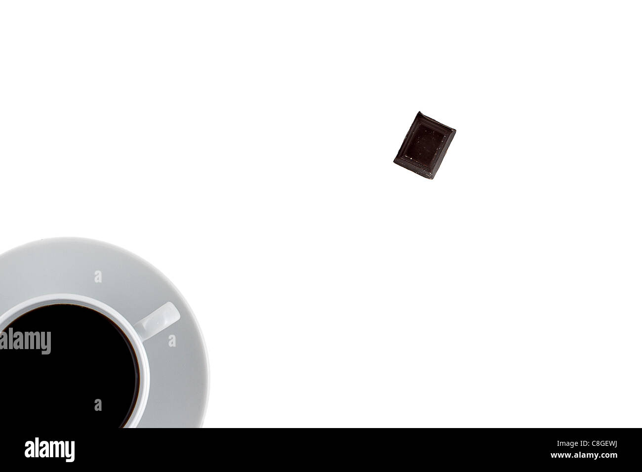 Minimilistic top view of coffee cup with black coffee and a piece of chocolade Stock Photo