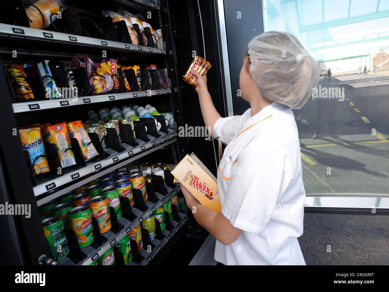 Woman restocking vending machine Stock Photo Alamy