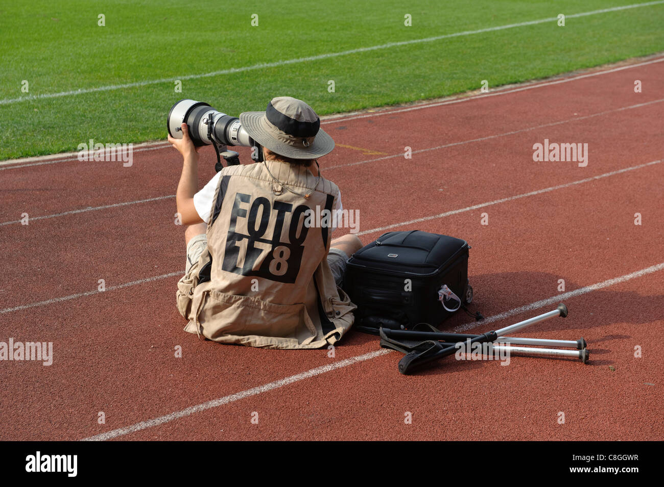 Professional photojournalist taking photos at sporting event Stock Photo