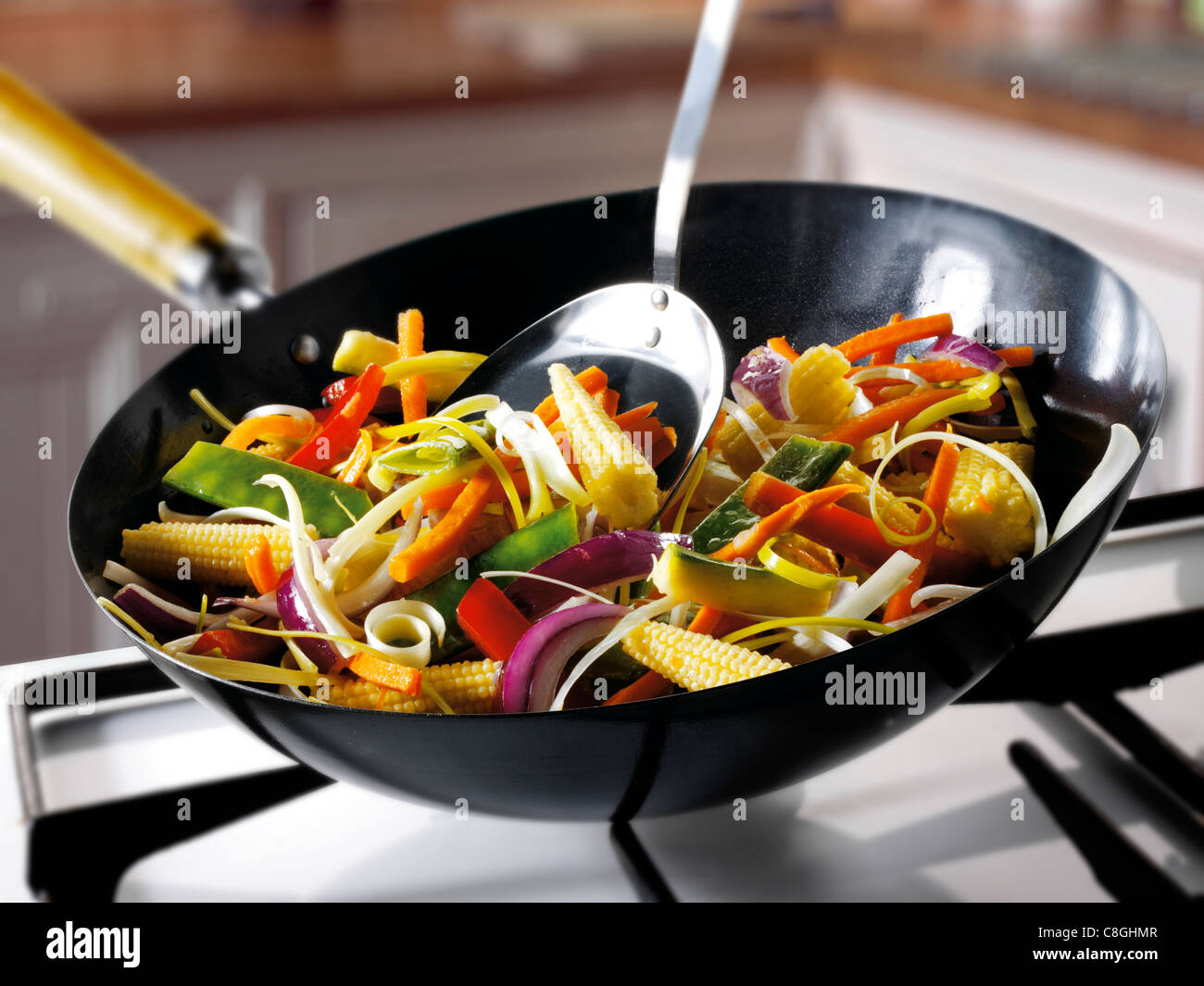 Corn stirfry being cooked in a wok Stock Photo