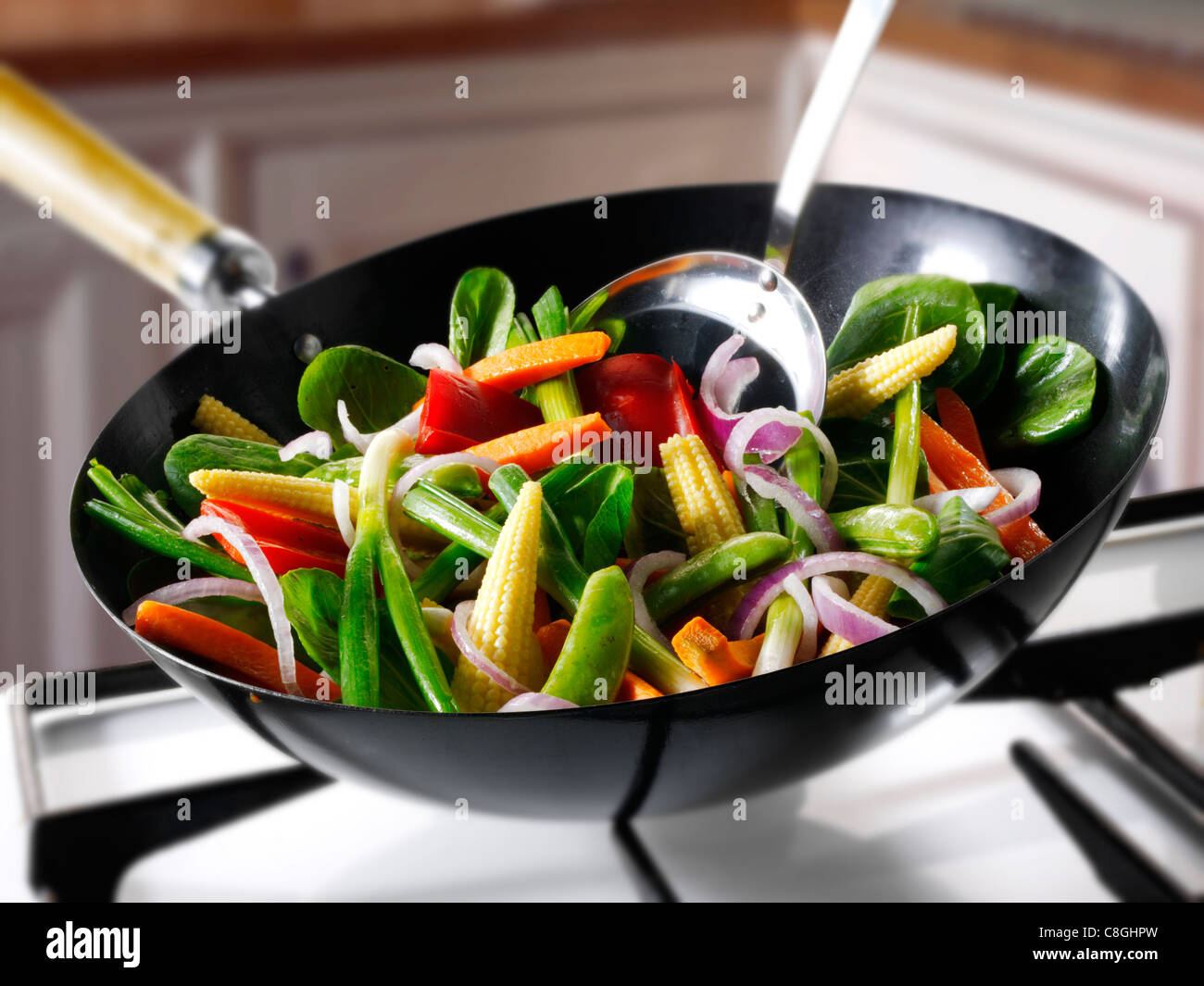 Stirfry cooking being cooked in a wok Stock Photo