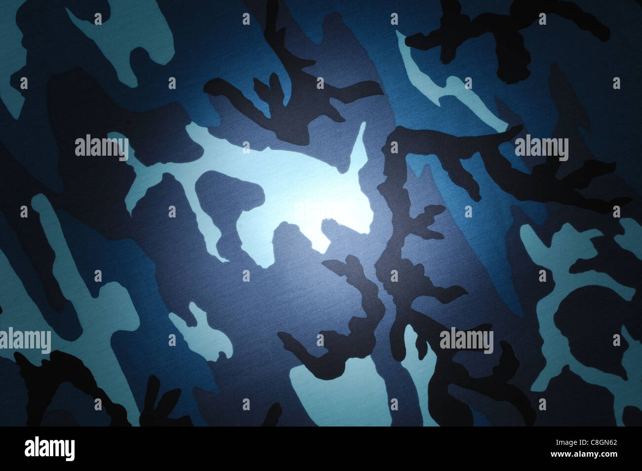 Spotlighting on shades of blue and black camouflage material Stock Photo