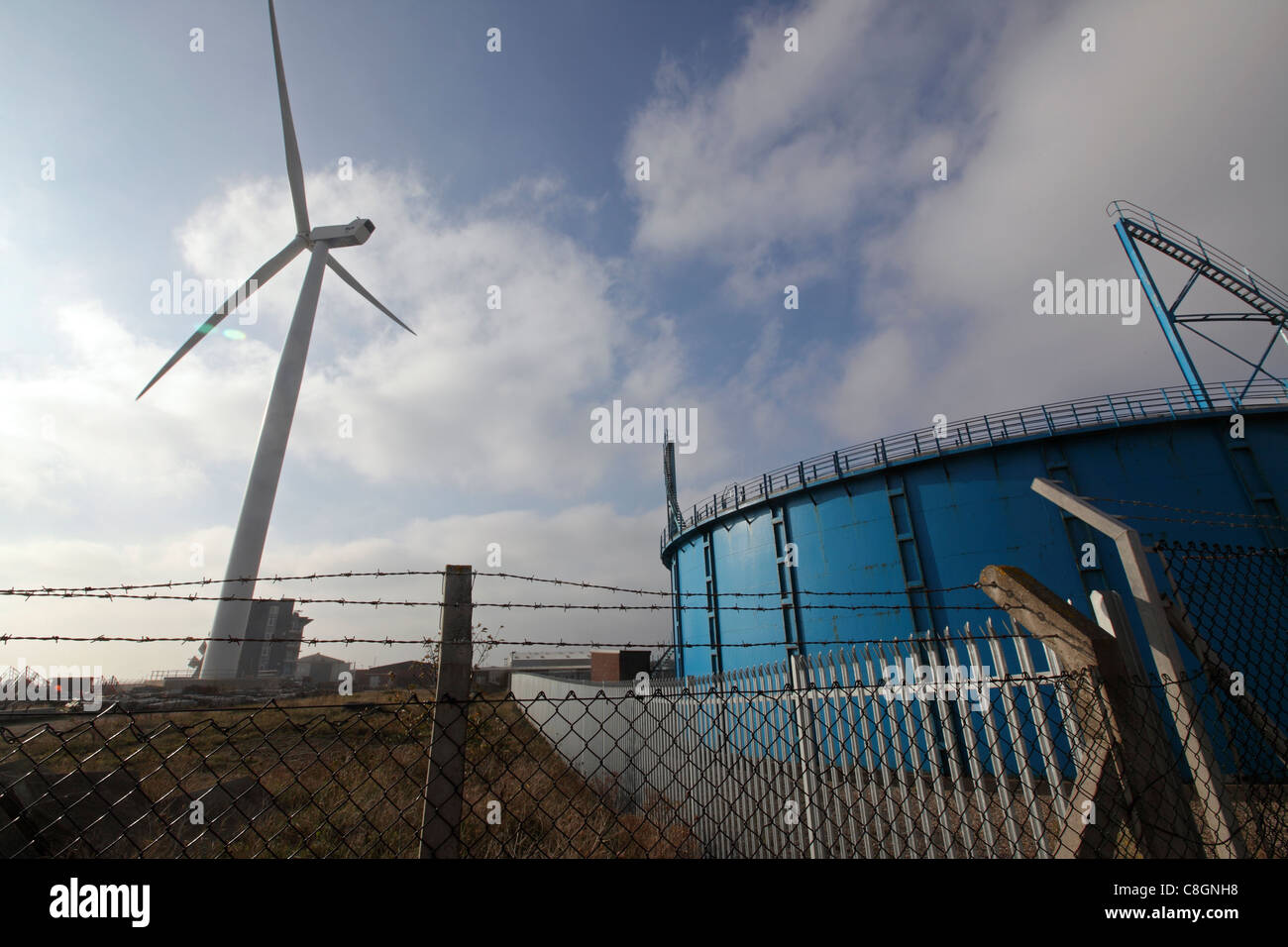 Large onshore wind turbine & gasometer / gas works, illustrating carbon based & sustainable energy side by side, Lowestoft Stock Photo