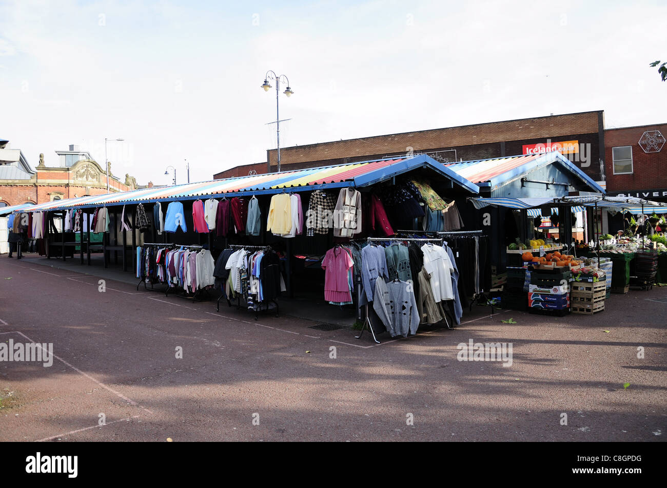 Ashton-under-Lyne market looking towards indoor market with clothing and fruit and vegetable stall Stock Photo