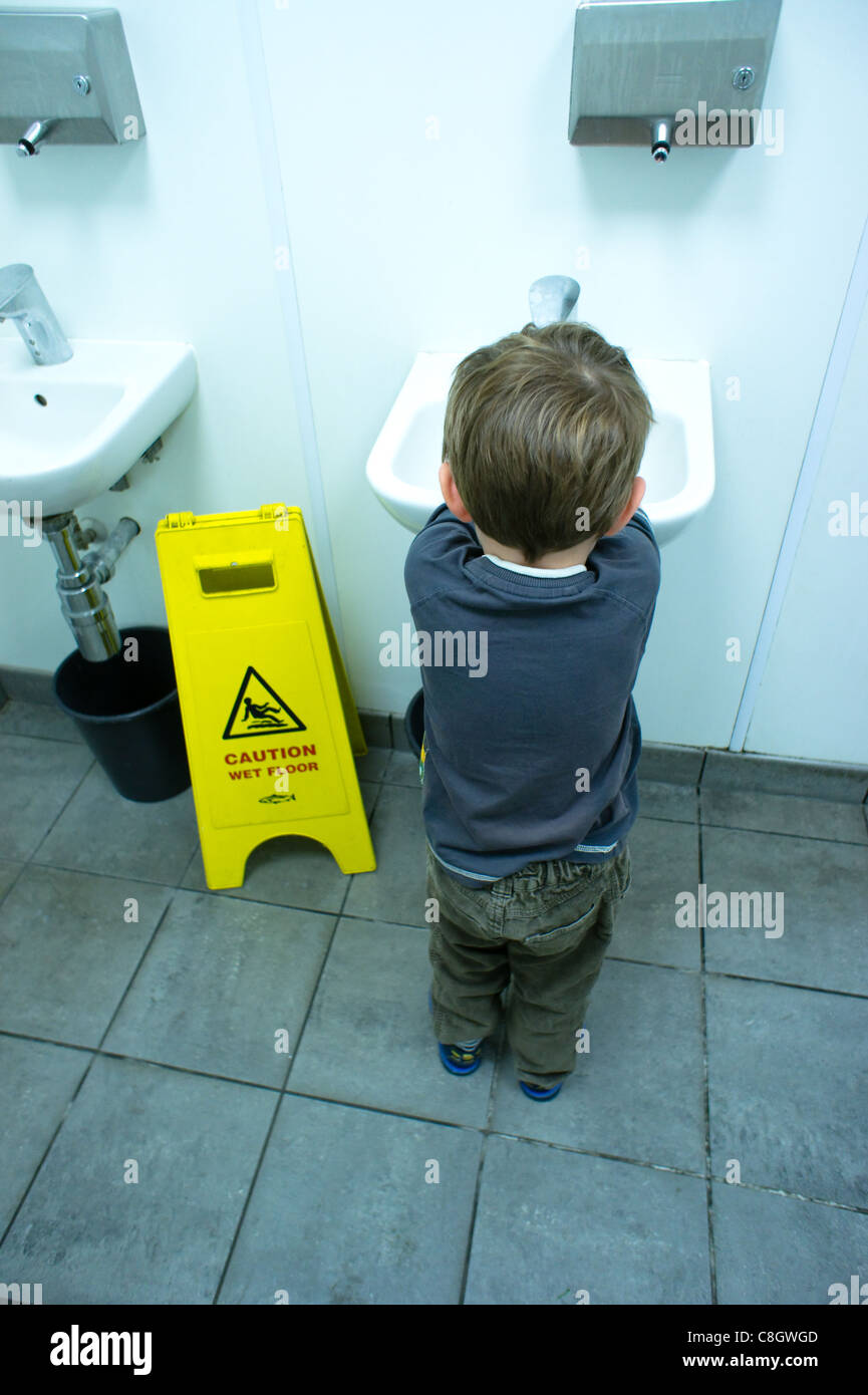 Young child washes hands in public bathroom Stock Photo Alamy