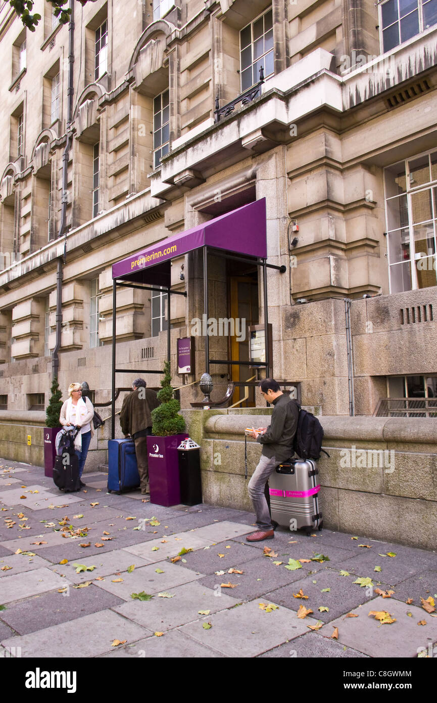 Guets with luggage outside Premier Inn, County Hall, London, October 2011 Stock Photo