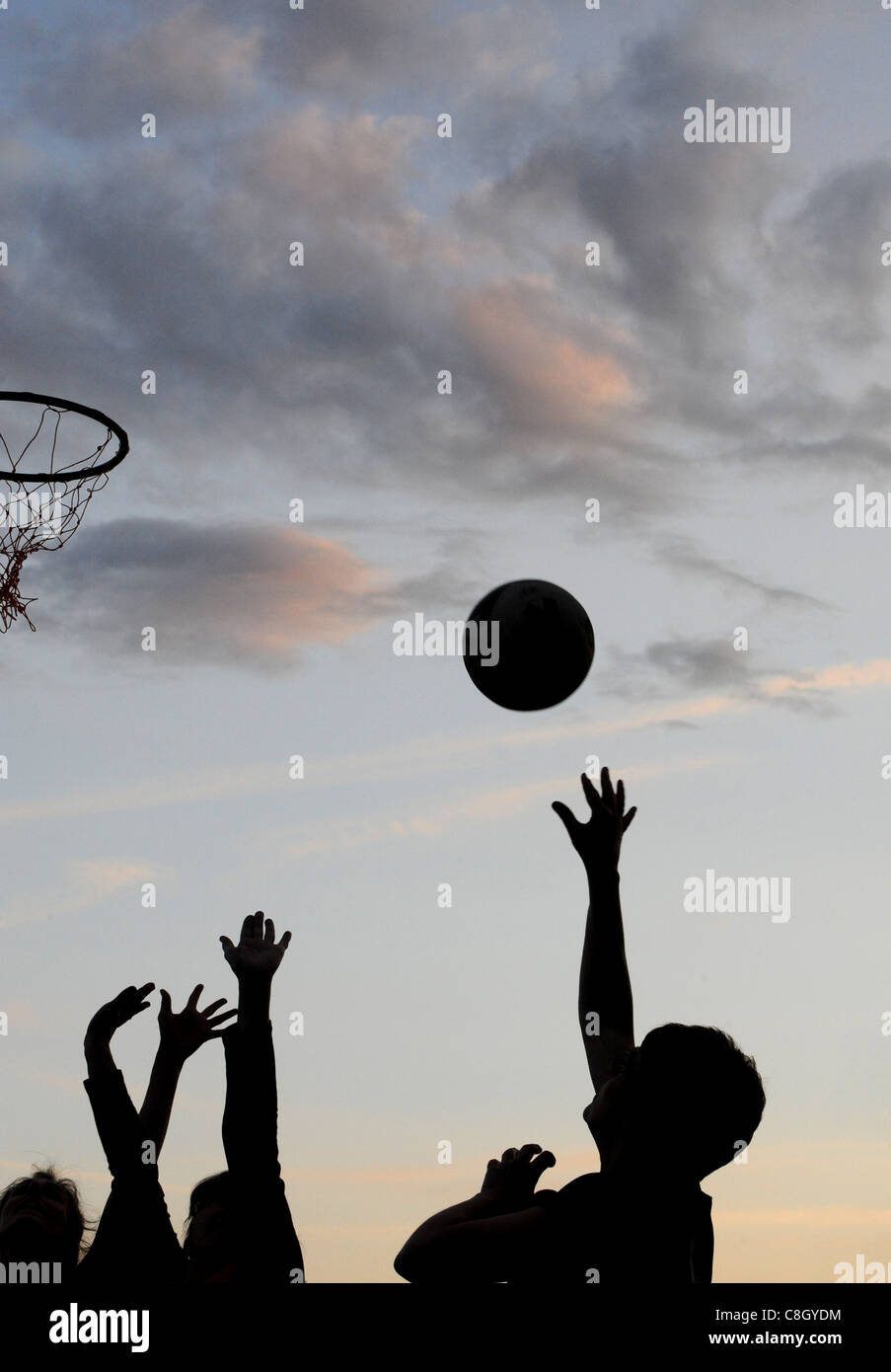 A female Netball player shooting a goal. Stock Photo