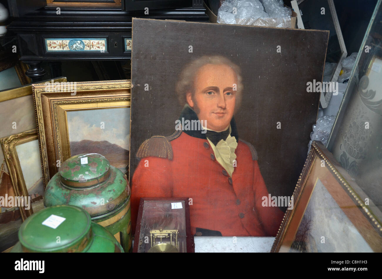Paintings and bric-a-brac in the window of a junk shop in Edinburgh's New Town. Stock Photo