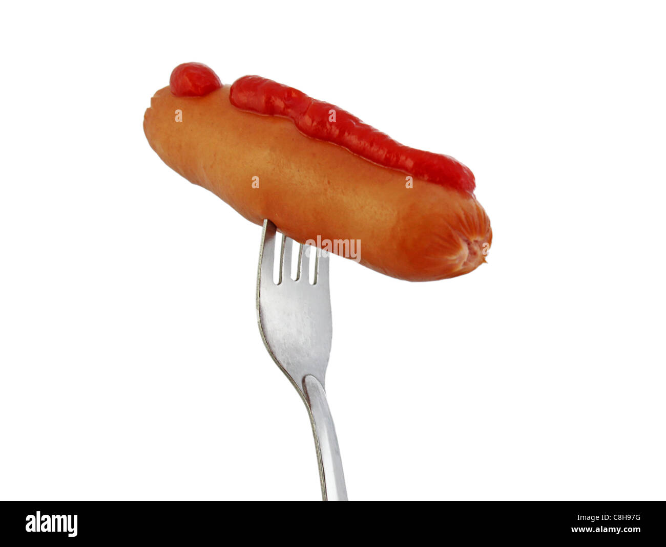 Sausage with ketchup on a fork isolated on white Stock Photo
