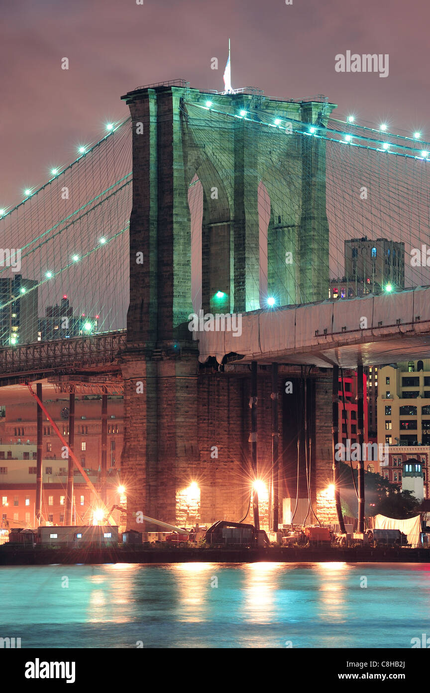 Brooklyn Bridge closeup over East River at night in New York City ...