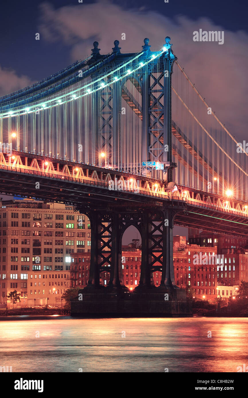 Manhattan Bridge closeup over East River at night in New York City ...