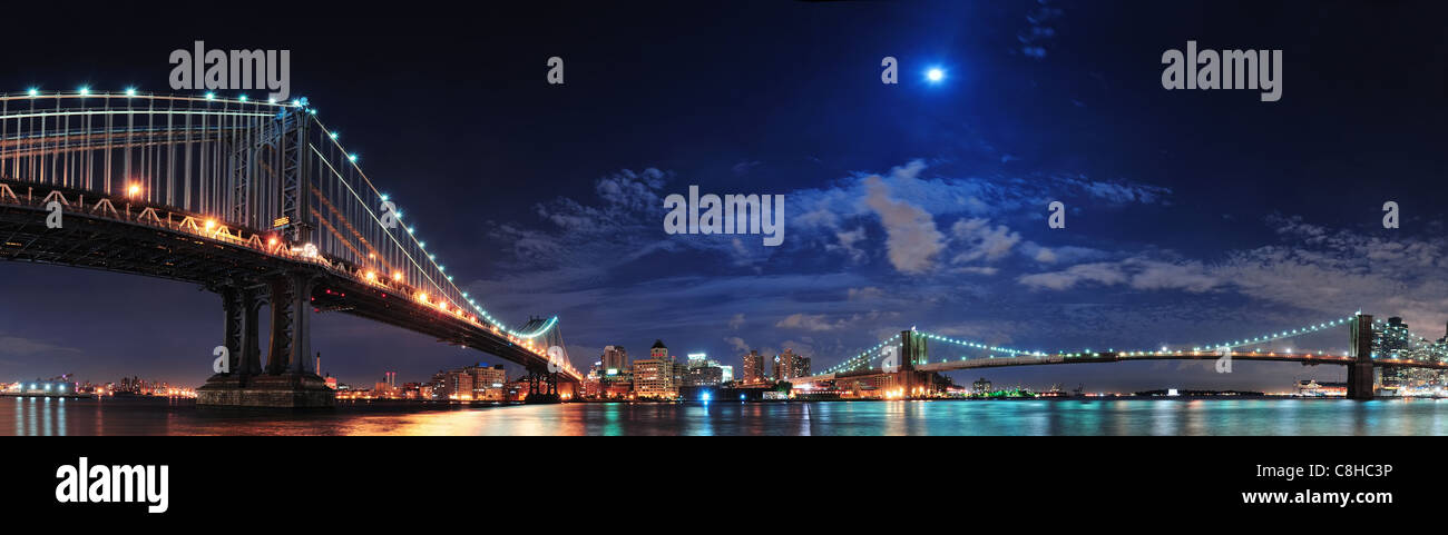 Brooklyn Bridge and Manhattan Bridge over East River at night with moon ...