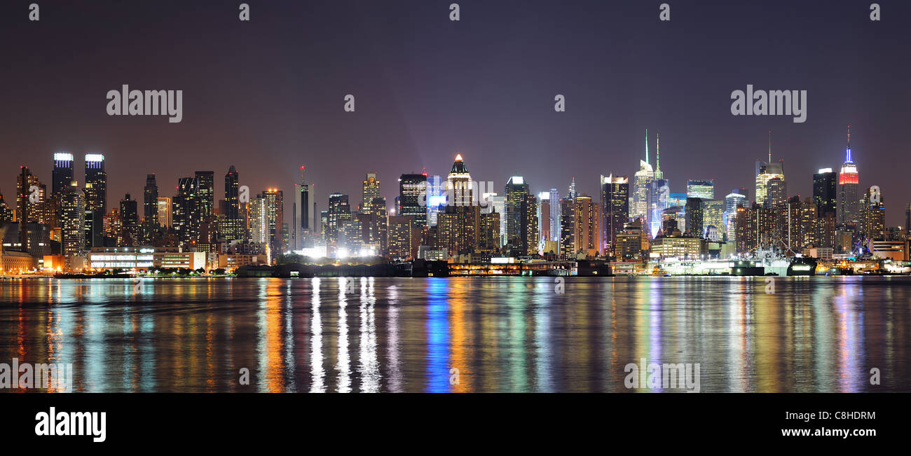 New York City Manhattan midtown skyline at night with lights reflection ...