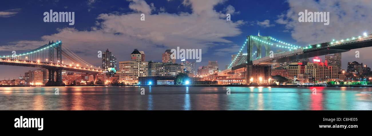 Brooklyn Bridge panorama over East River at night in New York City ...