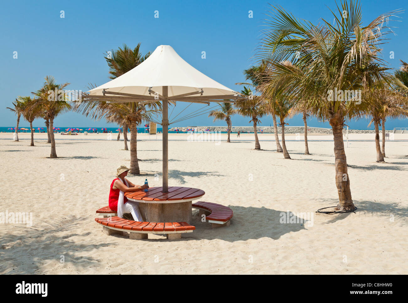Female tourist, Beach Umbrellas, Jumeirah Russian Beach, Dubai, United Arab Emirates, UAE Stock Photo
