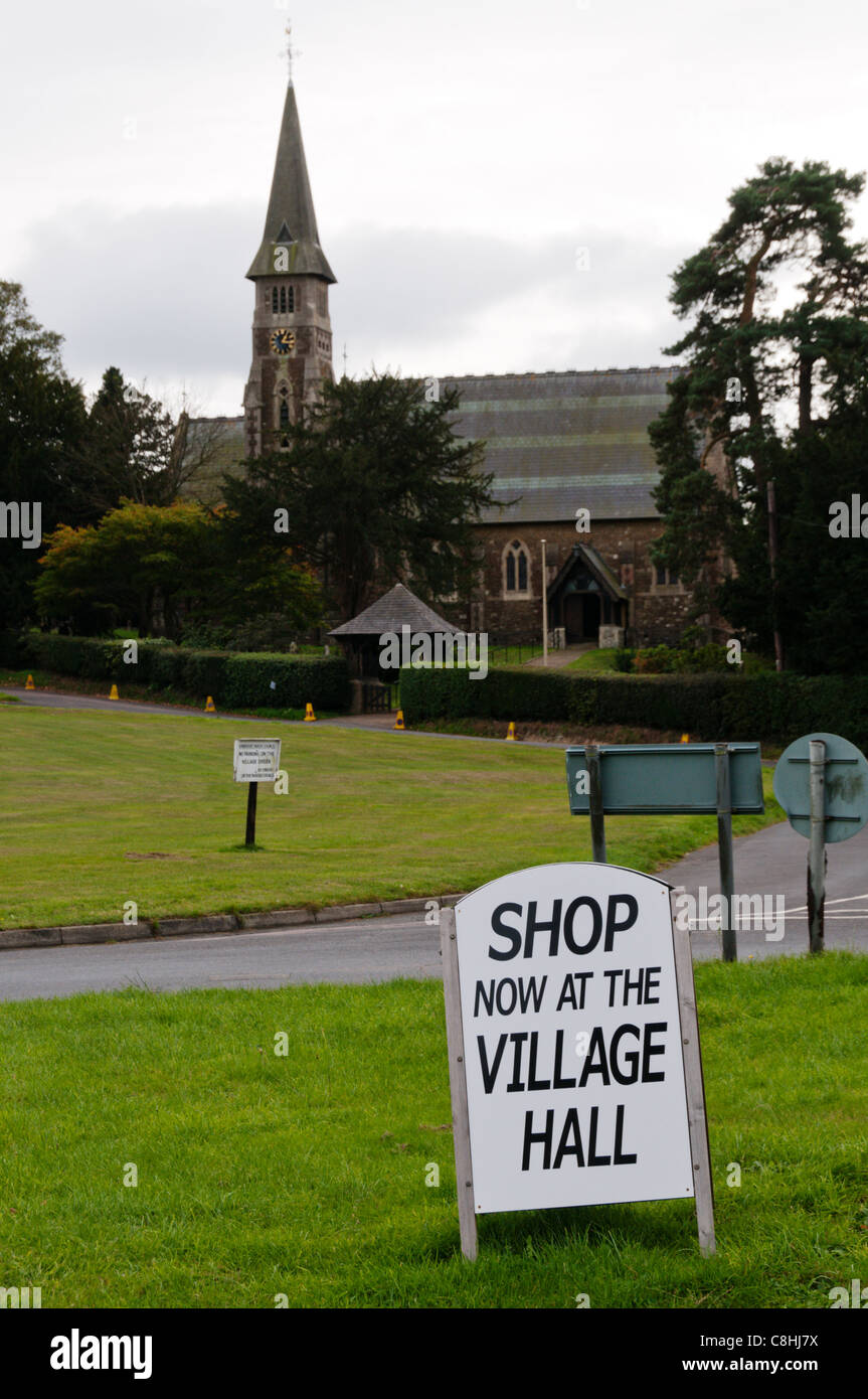 Shop Now In Village Hall sign. Stock Photo