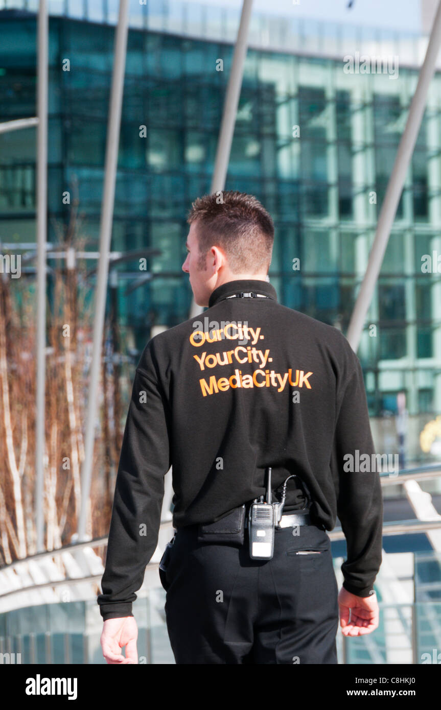 MediaCity name on sweatshirt of security guard at MediaCityUK, Salford Quays, Greater Manchester Stock Photo