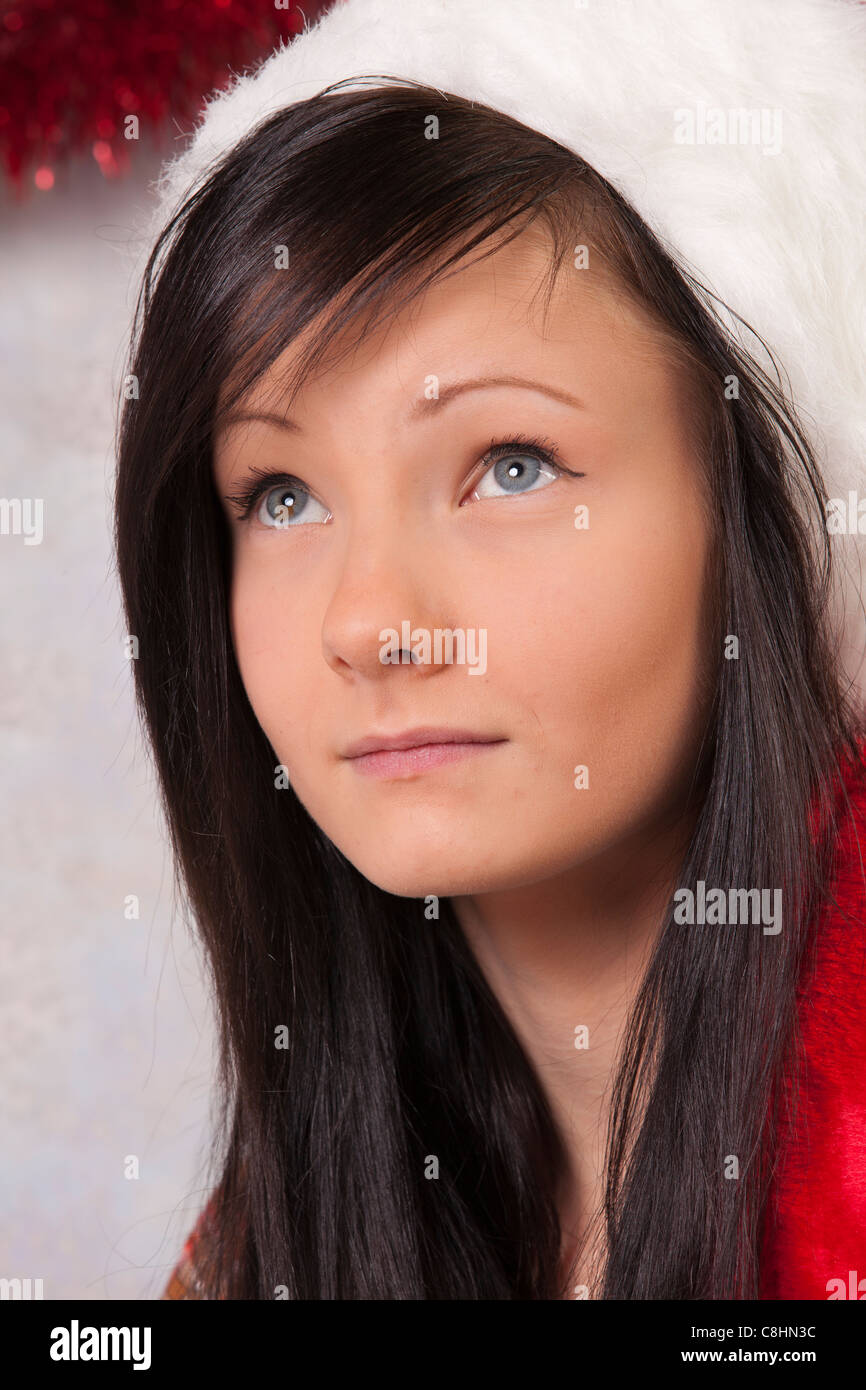 A Pretty Long Haired Young Teen Is Dressed As Christmas Elf