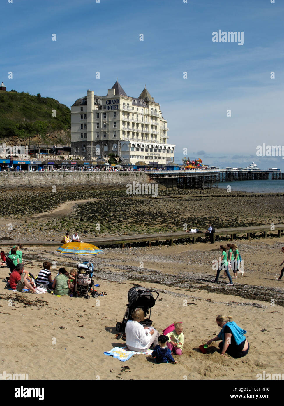 People sitting on the seafront in LLandudno Wales largest seaside resort North Wales Stock Photo