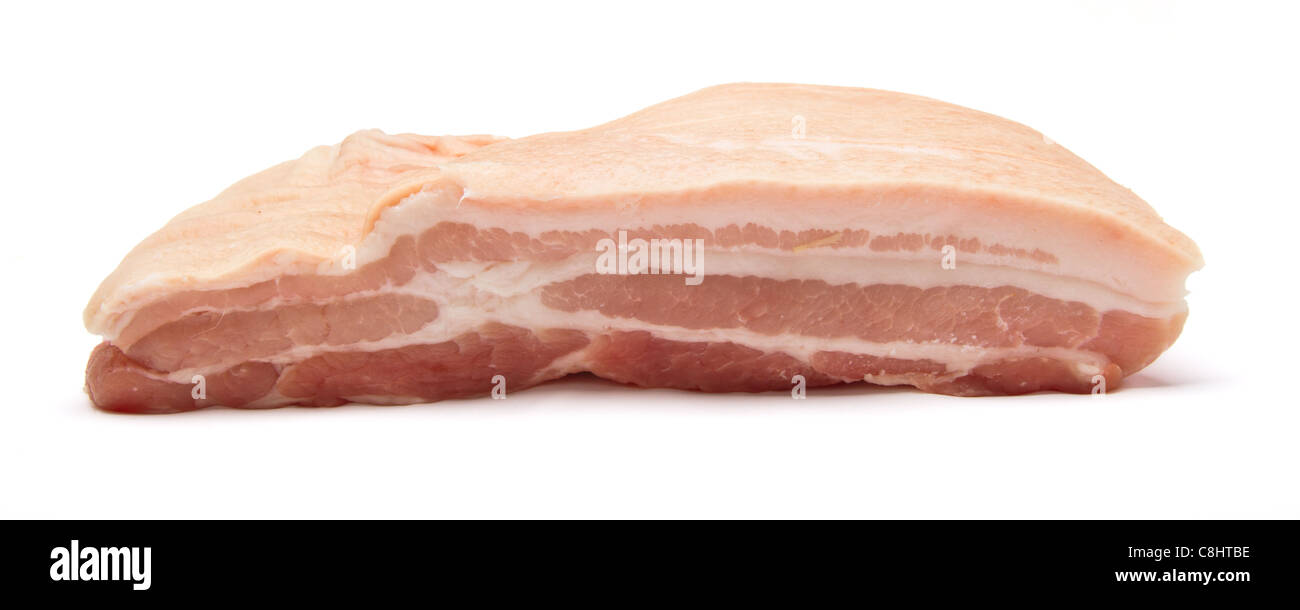 Slab of raw belly pork from low perspective isolated on white. Stock Photo