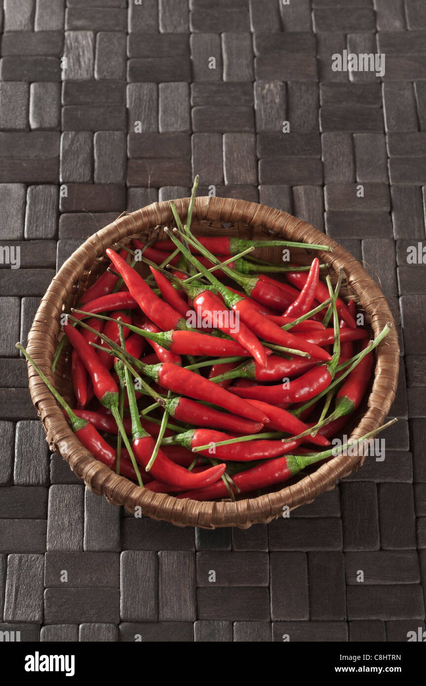 Red chillies on black wooden tiles Stock Photo