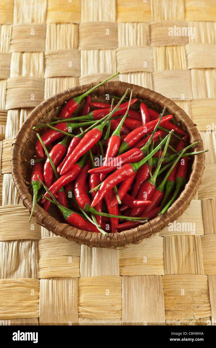Red chillies on plaited bamboo leaf Stock Photo