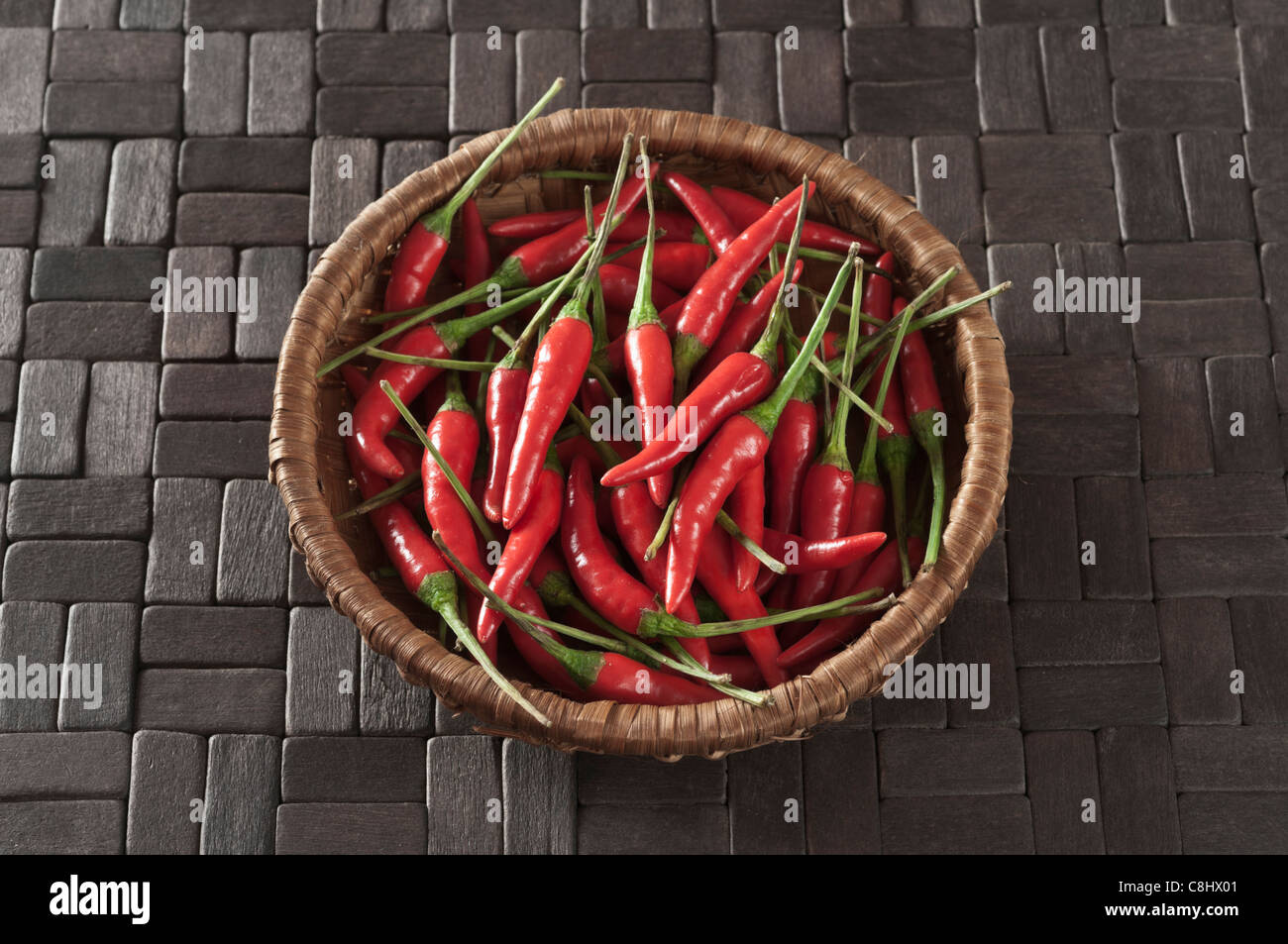 Red chillies on black wooden tiles Stock Photo