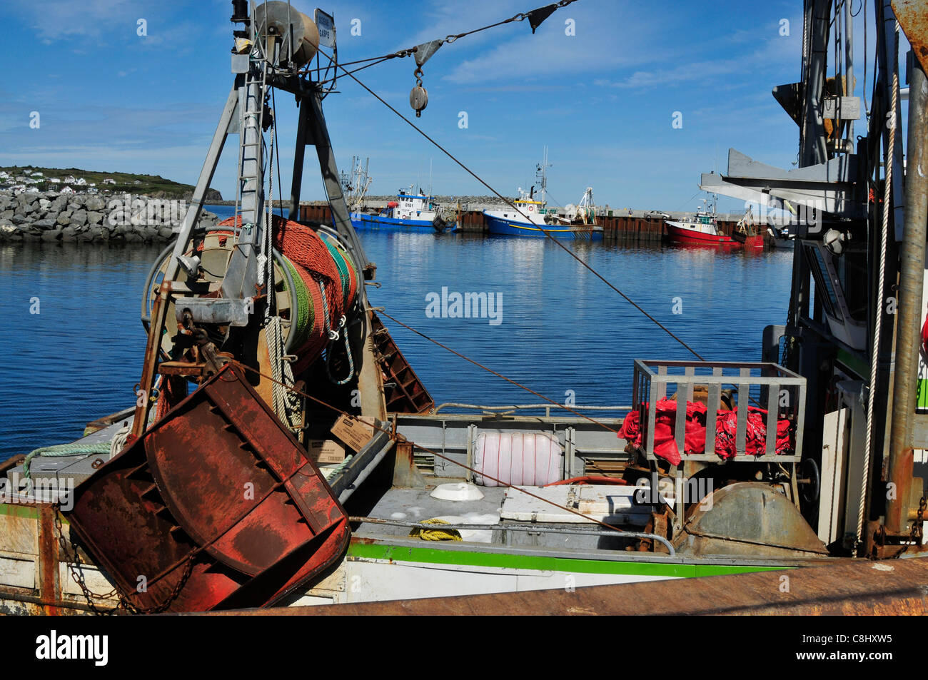 A closeup of a fishing trawlers with more trawlers in the background in Riviere aux Renard, in Quebec, Canada. Stock Photo