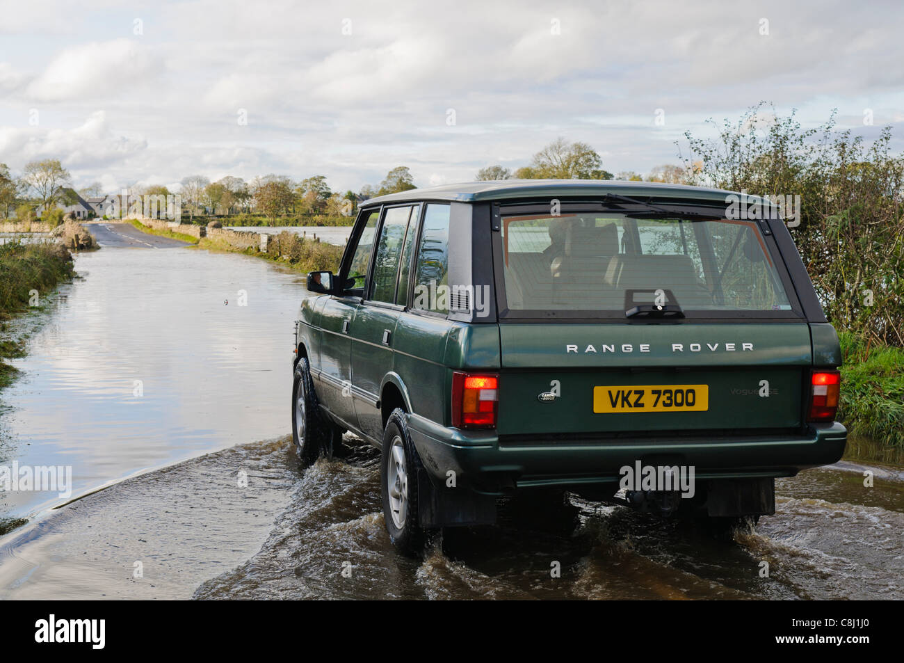 Man drives Range Rover through flooded rural road in Northern Ireland on Tuesday, 25th October, 2011. Stock Photo