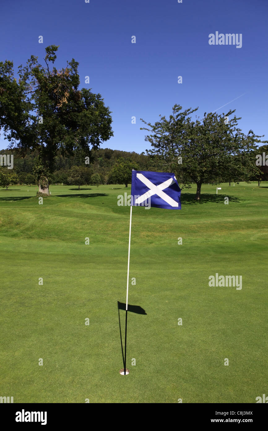 Golf course in Scotland with the Scottish St Andrews saltire flag on one of the greens Stock Photo