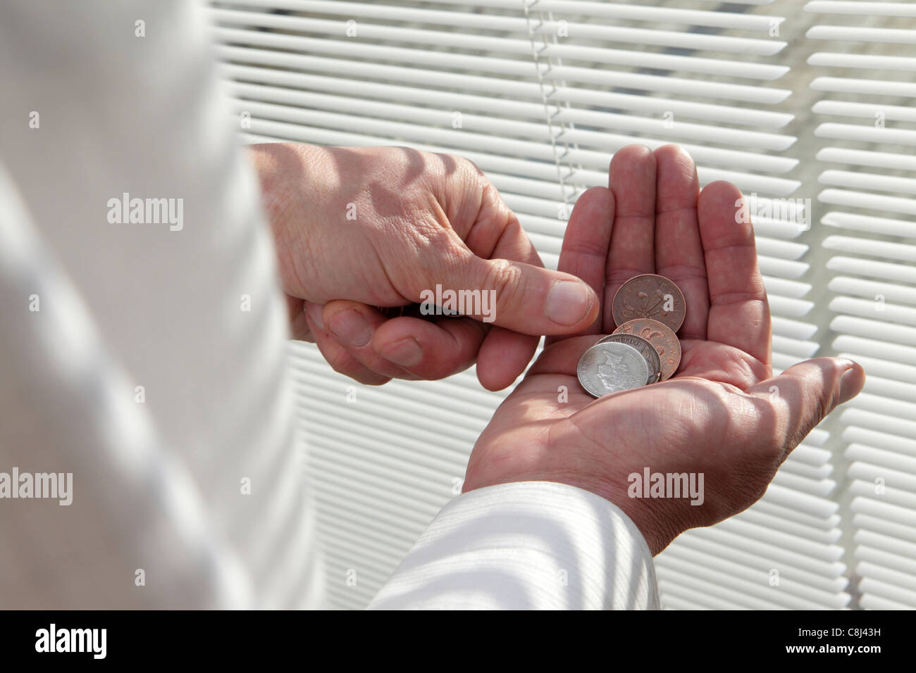 living on a tight budget, counting the pennies coins during a recession making ends meet, close-up of hands Stock Photo