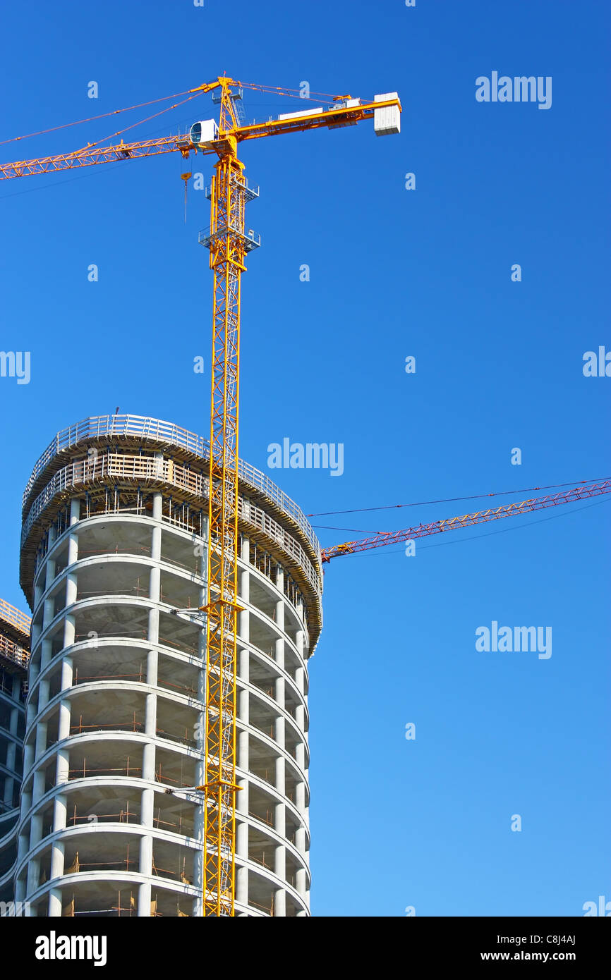 Construction crane building new business tower Stock Photo
