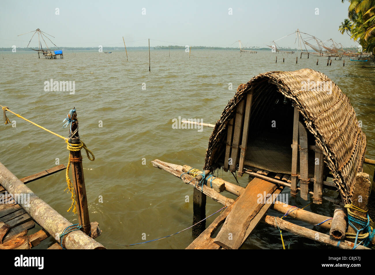 Chinese fishing nets on a tidal  lake near Fort Kochi ( Cochin ) showing the nets and basic shelter for the fishermen, Kerala, India Stock Photo