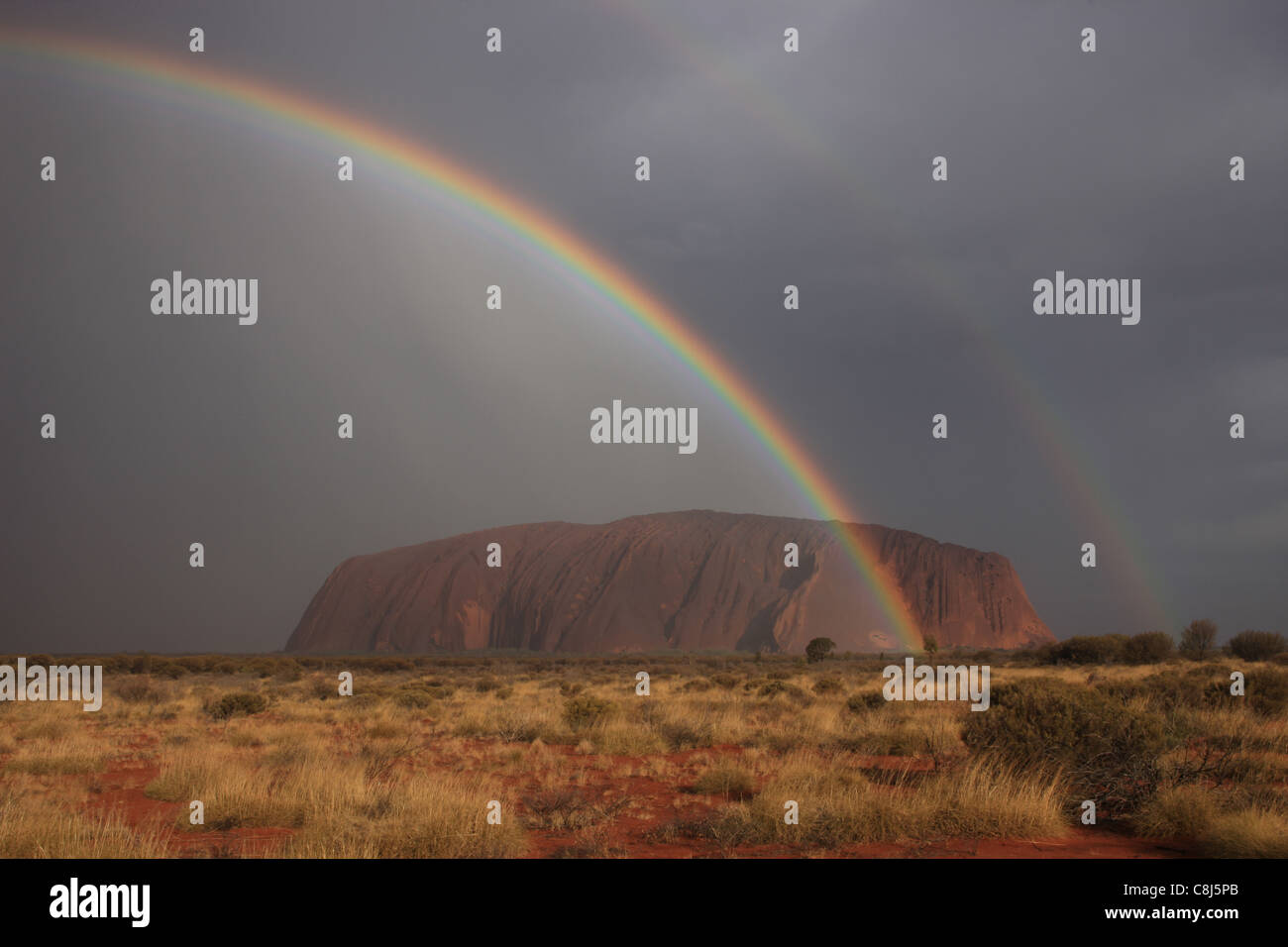 Ayers Rock, Uluru, Australia, Central australia, Outback, red sand, Spinifex, rainbow, clouds, Northern Territory, desert, Red C Stock Photo
