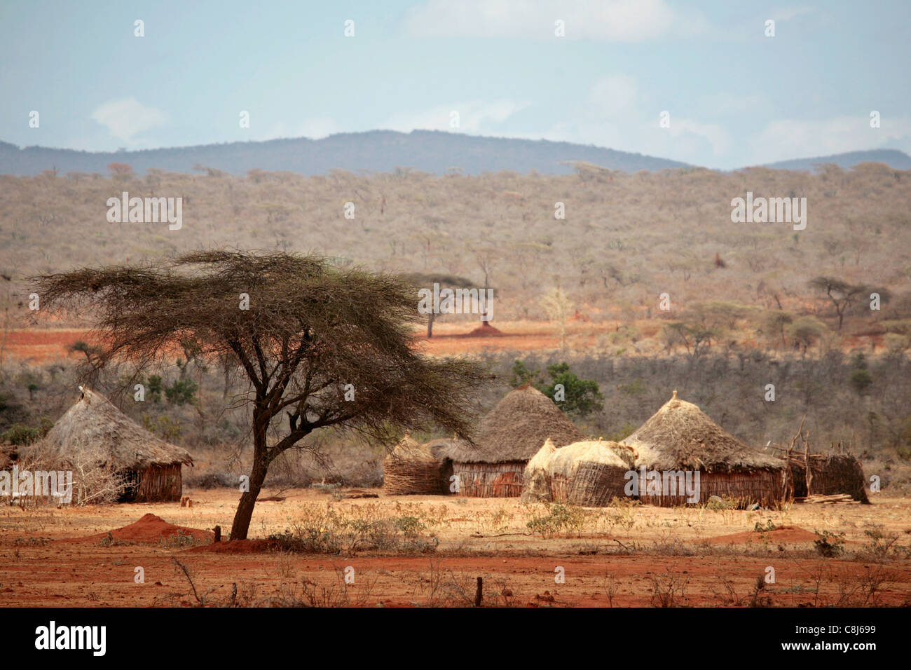 Adobe huts on the red-earth plains of Northern Kenya Stock Photo